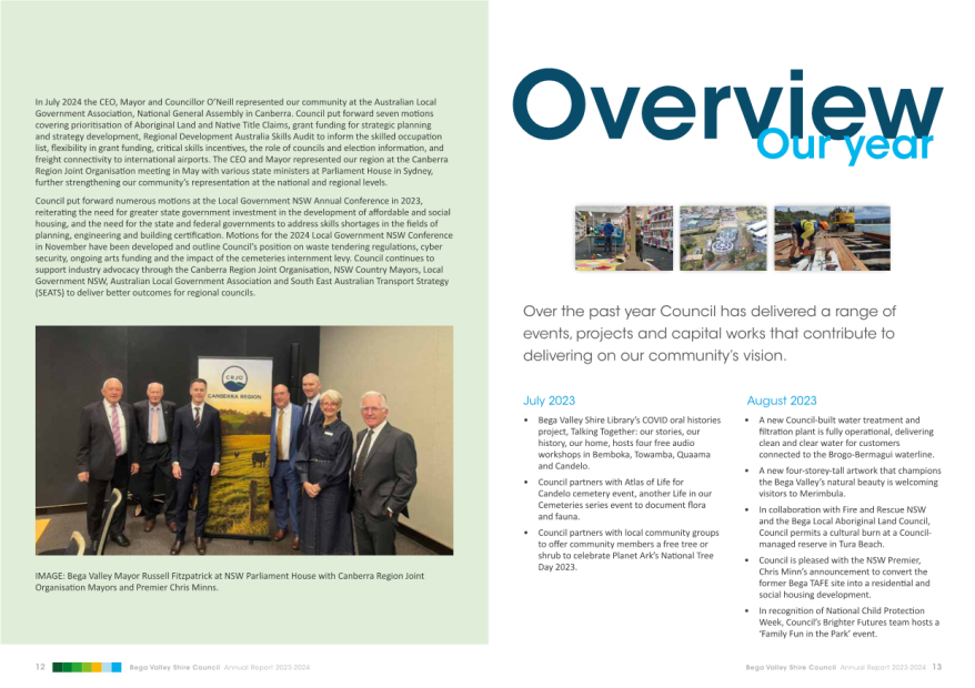 A group of men standing in front of a brochure

Description automatically generated