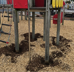 A playground with a hole in the ground

AI-generated content may be incorrect.