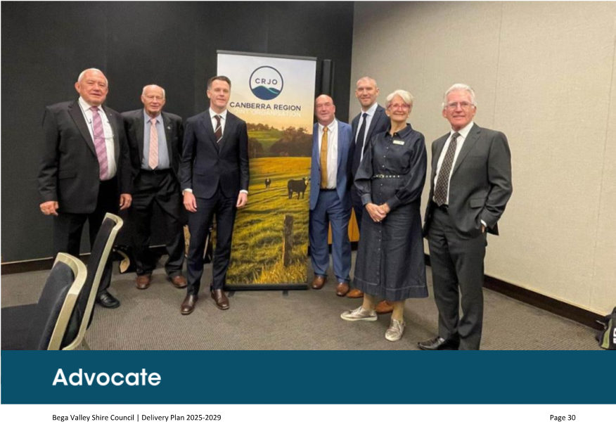 A group of people standing in a room

AI-generated content may be incorrect.