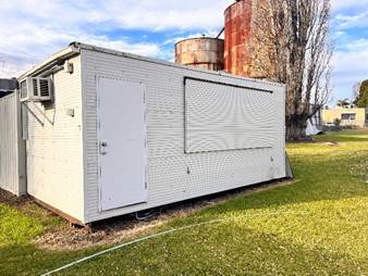 A white building in a grassy area

AI-generated content may be incorrect.