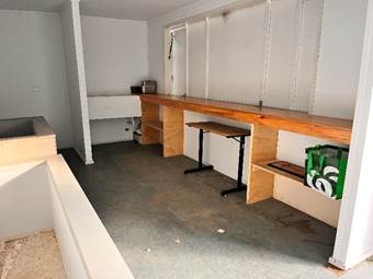A room with a table and benches

AI-generated content may be incorrect.