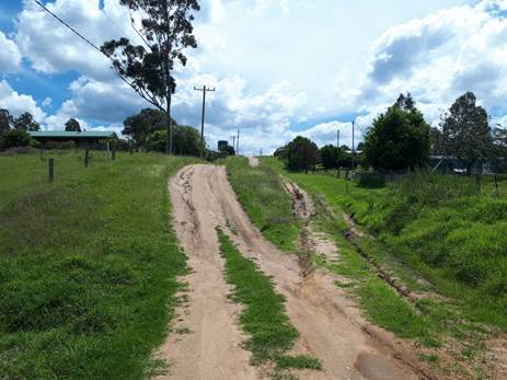 A dirt road with a few tires on it

AI-generated content may be incorrect.