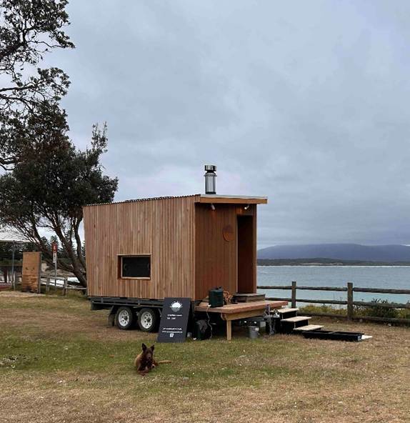 A small wooden house on wheels

AI-generated content may be incorrect.