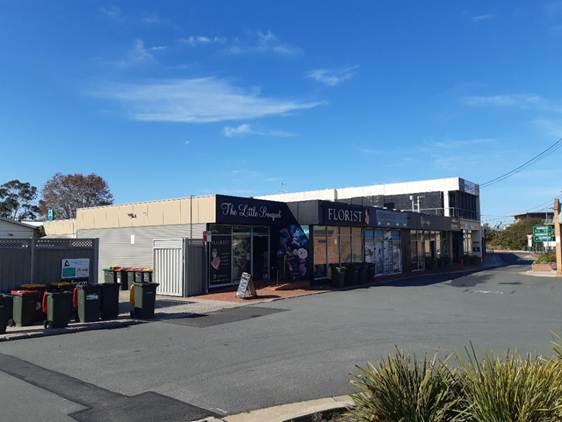 A building with shops on the side of the road

AI-generated content may be incorrect.